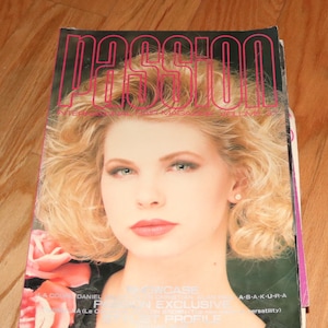 May include: A magazine cover with the word "Passion" in pink letters on a white background. A woman with blonde hair is featured on the cover, wearing a white shirt and looking at the camera. The magazine cover has a pink flower on the bottom left corner.