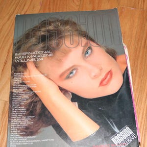 May include: A magazine cover featuring a woman with long brown hair and blue eyes. The magazine is titled "International Hair Magazine, Volume 24" and has the text "Pagoda Exclusive" on the bottom right corner.