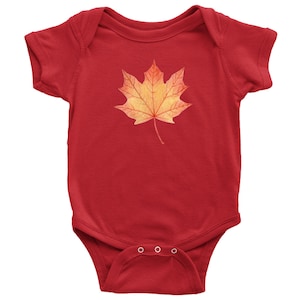 May include: Red baby onesie with a watercolor-style orange and yellow maple leaf design.