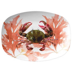 May include: A white oval serving platter with a watercolor design of a red crab and pink seaweed.