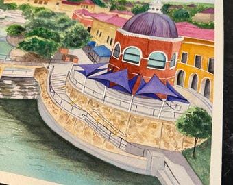 May include: A watercolor painting depicting an urban waterfront scene with a prominent red building featuring a dark purple dome. The structure includes blue triangular shade sails, stone retaining walls, a staircase, and a calm body of water.
