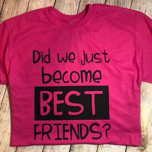 Peut inclure: T-shirt rose avec du texte noir qui dit "Did we just become BEST FRIENDS?"