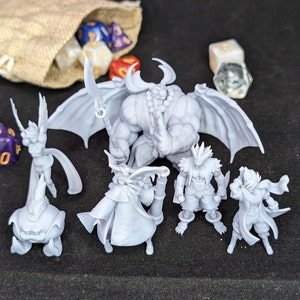 May include: A set of six grey 3D printed miniature figurines, including a demon, a wizard, a warrior, a goblin, a fairy, and a creature with a large head. The figurines are posed in a variety of action poses.