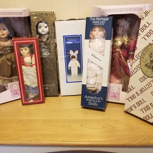 Porcelain Dolls in Boxes (8). SOLD SEPERATELY.