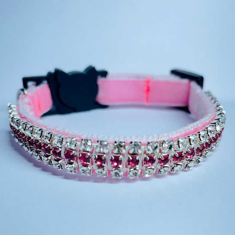 May include: Pink cat collar with a double row of rhinestones, featuring clear and pink crystals.