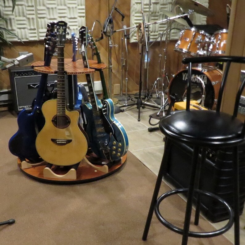 The Carousel Wood Rotating Multi Guitar Stand Holds Acoustics