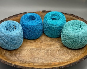 4oz Tencel yarn in shades of blues and greens