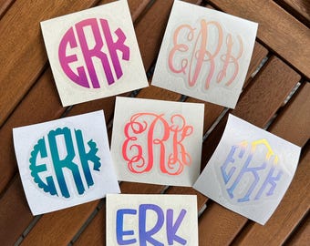 May include: Six different monogram stickers with the letters "ERK" in various styles and colors. The stickers are on white backgrounds.