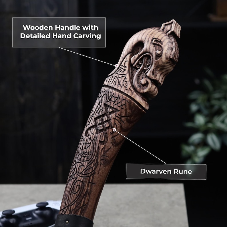 May include: A wooden handle with detailed hand carving, featuring a Dwarven rune design. The handle is dark brown with intricate carvings, including a face at the top. The text "Wooden Handle with Detailed Hand Carving" and "Dwarven Rune" are visible.