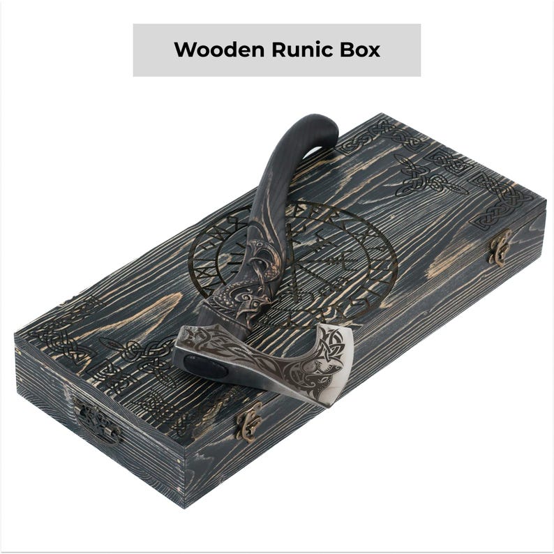 May include: A black axe with a wooden handle and intricate carvings is displayed in a wooden box with a runic design. The box is labeled "Wooden Runic Box".