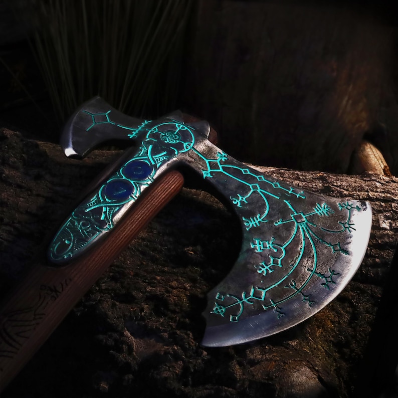 May include: A detailed axe with a dark metal head and a wooden handle. The axe head features intricate teal-colored glowing designs and three blue insets. The handle is a dark brown color.