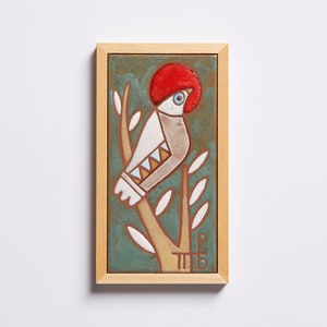 The bird tile – Add Some Forest Decor to Your Home!  Featuring a highly realistic image of a bird resting on a branch in the woods, this lovely tile is the perfect way to bring the beauty of nature into your home.