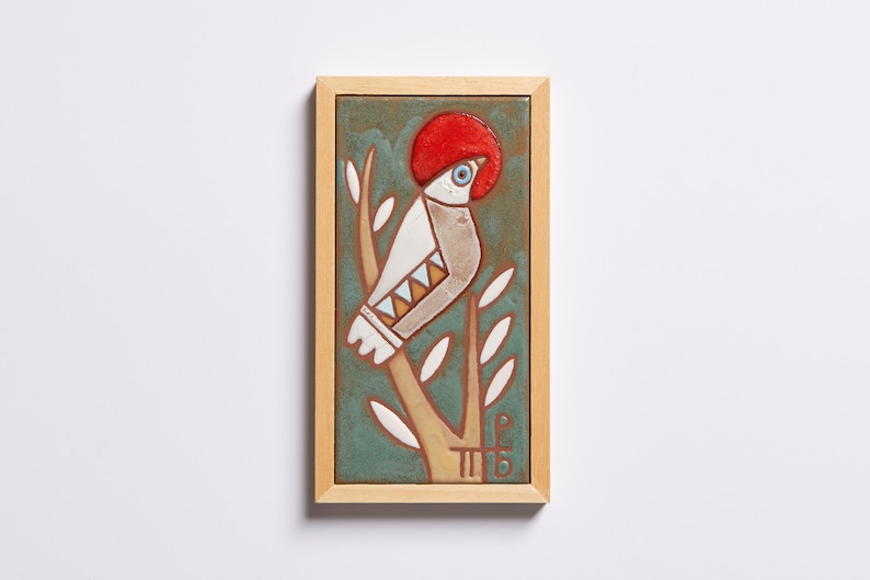 The bird tile – Add Some Forest Decor to Your Home!  Featuring a highly realistic image of a bird resting on a branch in the woods, this lovely tile is the perfect way to bring the beauty of nature into your home.