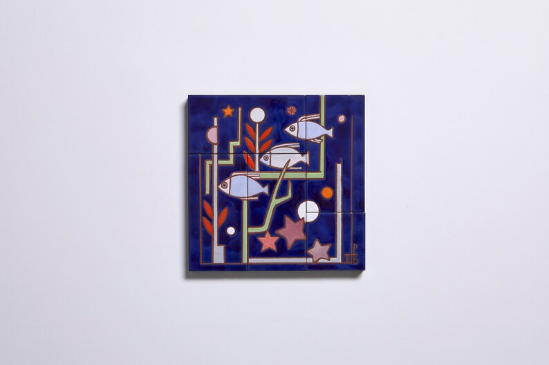 May include: A blue ceramic tile with a geometric design featuring three white fish, red and green plant-like shapes, and white and pink circles. The tile is divided into nine smaller squares.