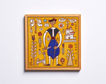 May include: A framed ceramic tile with a yellow background and a colorful illustration of a person in traditional clothing, a dog, and various floral and geometric patterns.