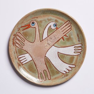 Introducing the Two Birds Ceramic Plate, a beautiful and timeless piece of craftsmanship. Expertly crafted from fine ceramic with an earthy and warm color palette, this plate offers a sophisticated yet inviting look that will last for years.