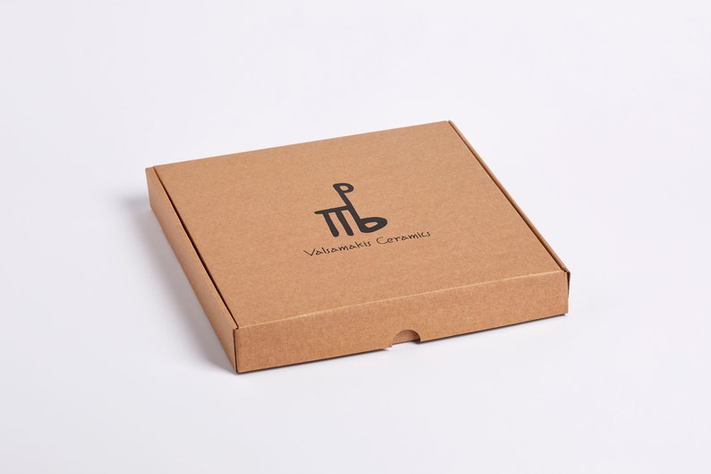 May include: A brown cardboard box with the text "Vallamaki Ceramics" and a stylized logo printed on the top.