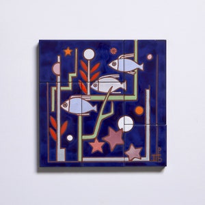 May include: A blue ceramic tile with a geometric design featuring three white fish, red and green plants, and white and pink stars. The tile is part of a larger mosaic.