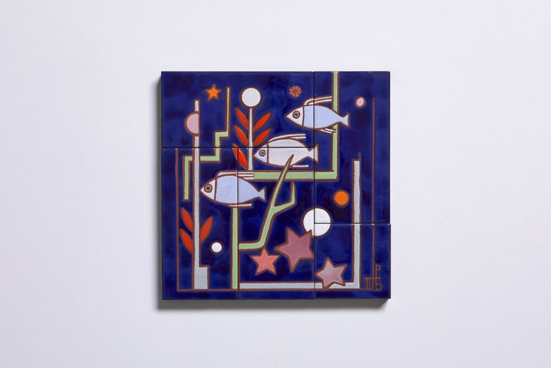 May include: A blue ceramic tile with a geometric design featuring three white fish, red and green plants, and white and pink stars. The tile is part of a larger mosaic.