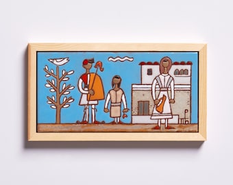 May include: A framed ceramic tile with a blue background depicting a family of three in traditional clothing. The father is holding a staff, the mother is holding a pitcher, and the child is standing between them. A white bird is perched on a tree branch in the background. The tile is framed in a light wood frame.