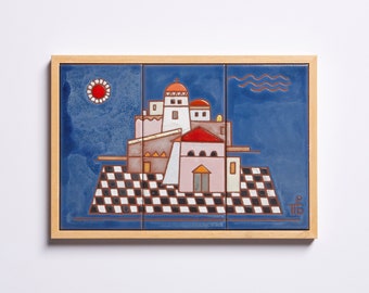 May include: A framed ceramic tile artwork depicting a stylized cityscape with a red sun, blue sky, and white buildings. The tile is set against a blue background with a checkered pattern in the foreground.