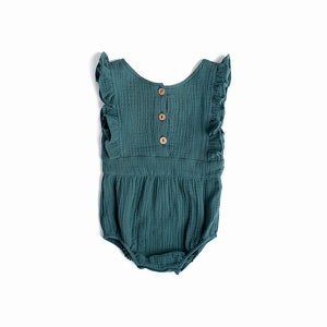 May include: A teal blue baby onesie with ruffled sleeves and a button closure in the back.