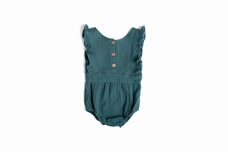 May include: A teal blue baby onesie with ruffled sleeves and a button closure in the back.