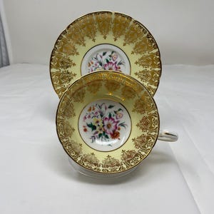 Paragon Teacup and Saucer Yellow and Gold Gild with Flowers.