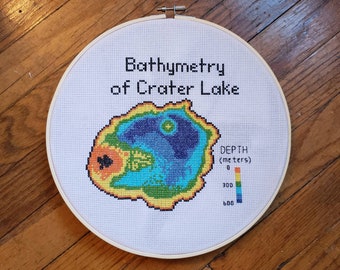 Crater Lake Bathymetry completed cross stitch, framed in 10 inch hoop