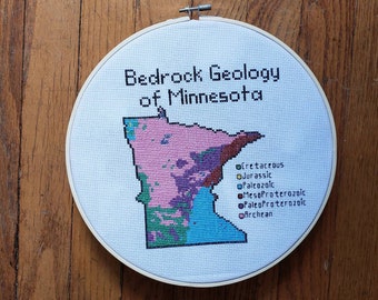 Minnesota Bedrock Geology completed cross stitch, framed in 10 inch hoop