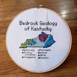 Kentucky Bedrock Geology completed cross stitch, framed in 9 inch hoop