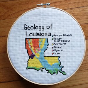 Louisiana Bedrock Geology completed cross stitch, framed in 9 inch hoop