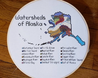 Watersheds of Alaska, completed cross stitch, framed in 10 inch hoop