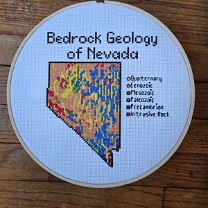 Nevada Bedrock Geology completed cross stitch, framed in 9 inch hoop