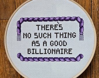 There's No Such Thing as a Good Billionaire, completed cross stitch, framed in 6 inch hoop