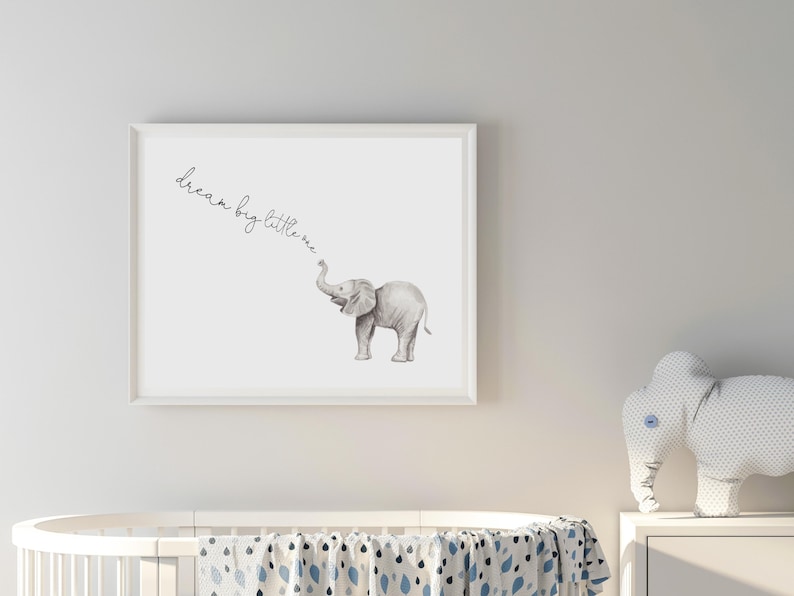 May include: A white framed print with a watercolor illustration of a grey elephant with the text "dream big little one" written in cursive.