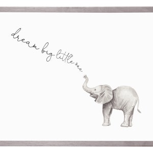 May include: A framed print with a black and white illustration of a baby elephant with its trunk raised. The text "dream big little one" is written in cursive above the elephant.