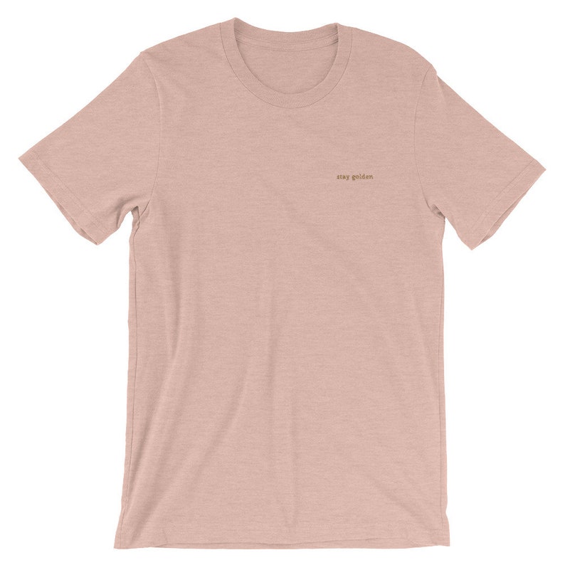 Heather Prism Peach short-sleeve tee with the phrase Stay Golden embroidered in gold thread.