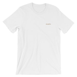 White short-sleeve tee with the phrase Stay Golden embroidered in gold thread.