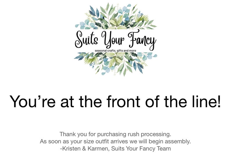 May include: White background with the text "You're at the front of the line!" and the Suits Your Fancy logo. The logo is a floral wreath with the text "Suits Your Fancy" and "seasonal crafts, gifts and more".