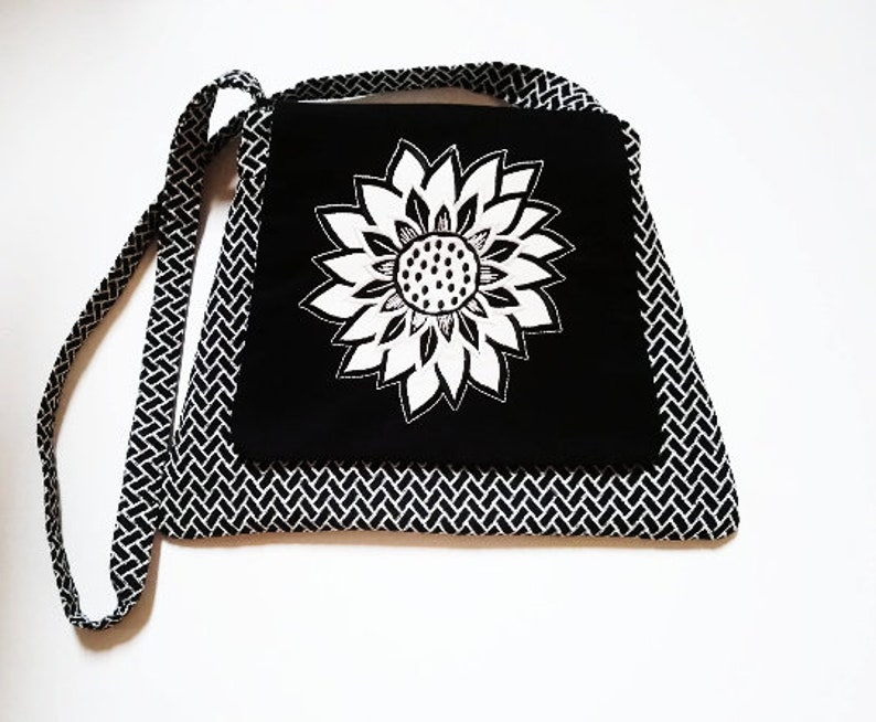 Sac à main pour femme en tissu Jacquard noir impressions blanches broderie fleur appliquée blanche sur rabat sac bandoulière. image 1