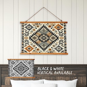 May include: A tapestry with a geometric pattern in shades of brown, black, and white. The tapestry is hanging on a white wall with a wooden frame. The text "BLACK & WHITE VERTICAL AVAILABLE" is written below the tapestry.
