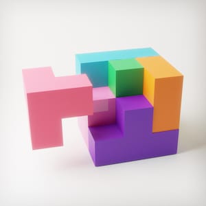 May include: A colorful geometric puzzle composed of various sized blocks in shades of pink, green, orange, purple, and blue. The blocks are arranged to form a cube with a detached piece.
