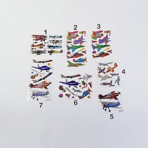 May include: Ten sheets of colorful airplane stickers. The stickers feature a variety of airplanes in different colors and designs. The stickers are perfect for adding a touch of fun to any project.