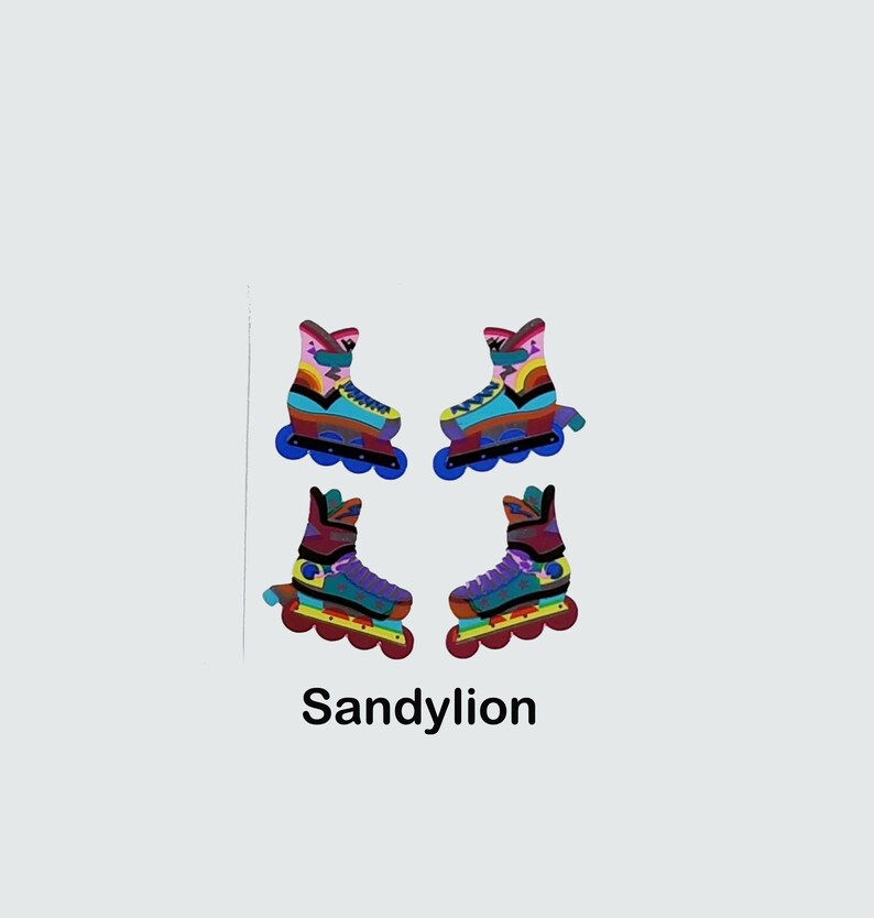 May include: Four colorful roller skate stickers with a rainbow design. The stickers are on a white background. The text "Sandylion" is below the stickers.