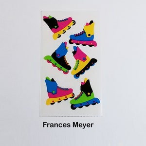 May include: A sheet of colorful roller skate stickers. The stickers feature black, blue, green, pink, and yellow roller skates with white wheels. The stickers are on a white background with the text "Frances Meyer" at the bottom.