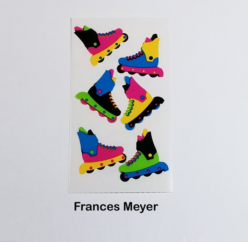 May include: A sheet of colorful roller skate stickers. The stickers feature black, blue, green, pink, and yellow roller skates with white wheels. The stickers are on a white background with the text "Frances Meyer" at the bottom.