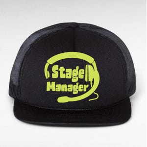 May include: Black trucker hat with a yellow graphic of headphones and the text "Stage Manager".