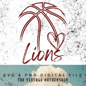 May include: A digital design showing a basketball graphic with a heart and the word "Lions" in dark red. The design is on a textured white background with black speckles. The bottom of the image includes the text "SVG & PNG DIGITAL FILE" and "THE VINTAGE MOTHERSHIP".