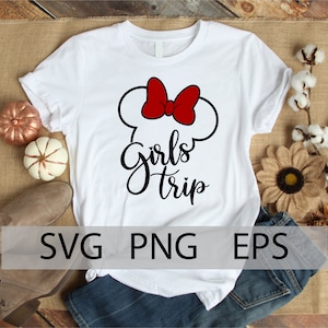 May include: White t-shirt with a black and red graphic design. The graphic features a stylized Mickey Mouse ear silhouette with a red bow and the text "Girls Trip".